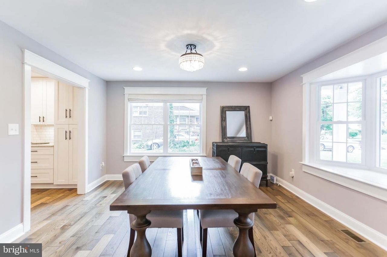 A large kitchen with white cabinets and granite counter tops.
