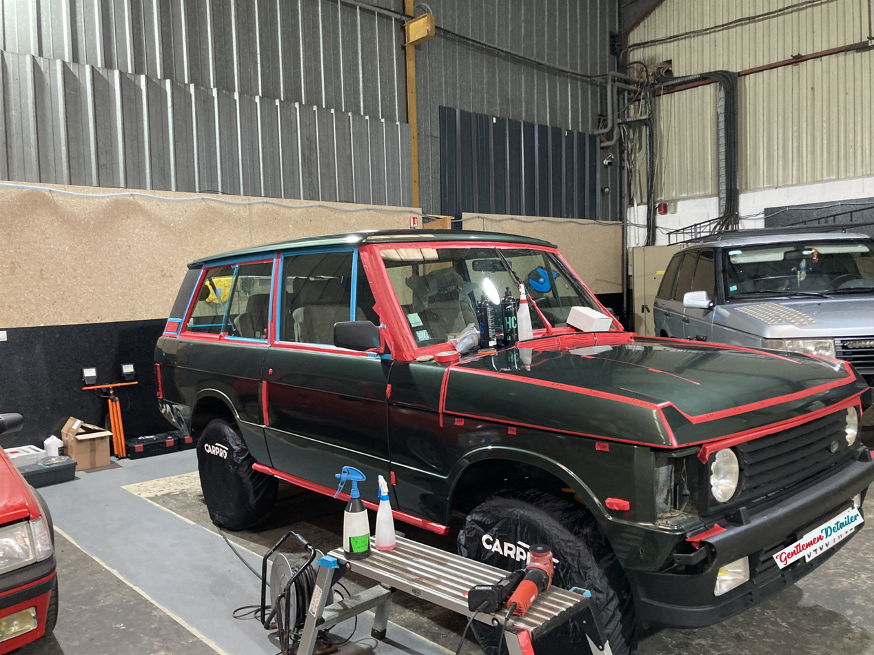 Un Range Rover est en cours de peinture dans un garage.