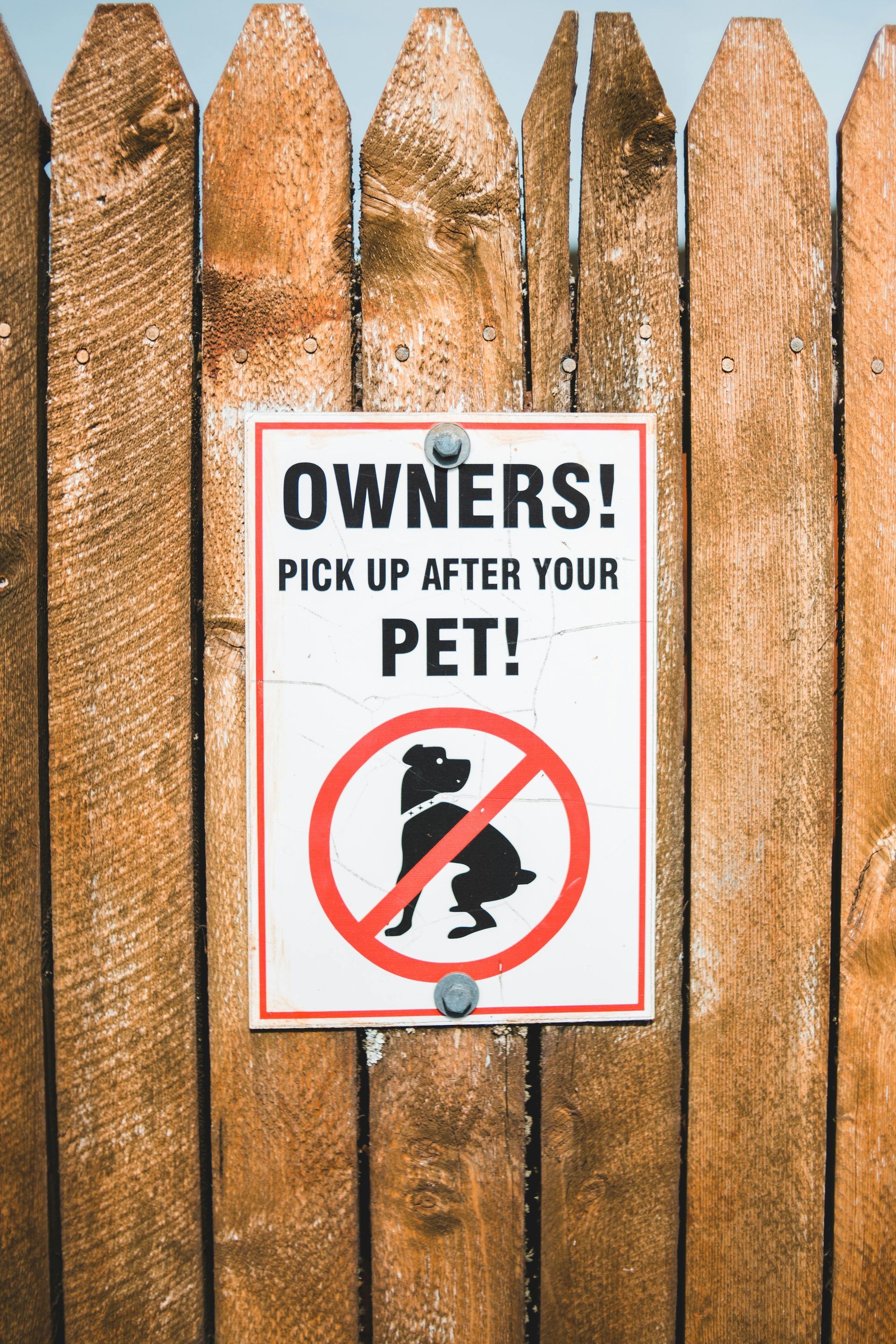 Sign on wooden fence: 