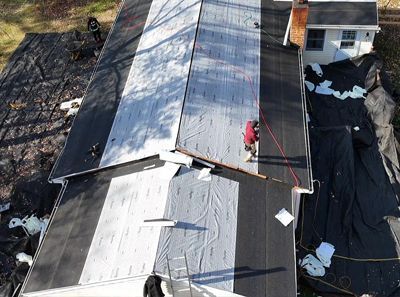 An aerial view of a roof being installed on a house.