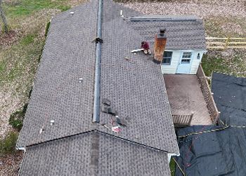 An aerial view of a house with a chimney on the roof.