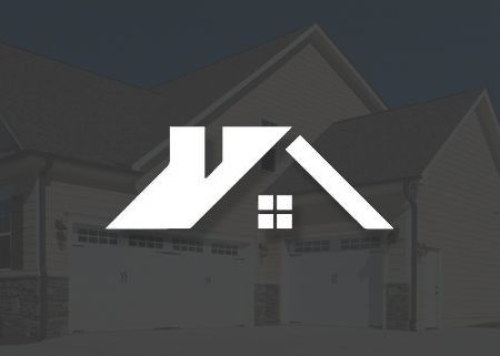 A logo for a real estate company with a house in the background