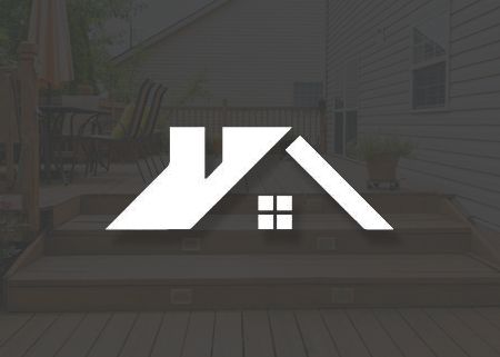 A logo for a real estate company is sitting on top of a wooden deck.