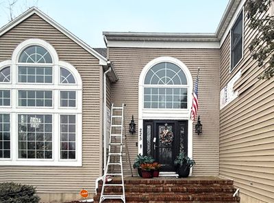 A large house with a ladder in front of it.