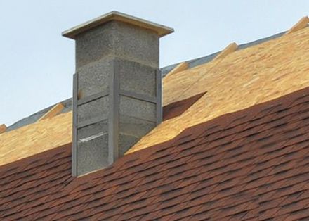 A chimney on top of a roof that is being built