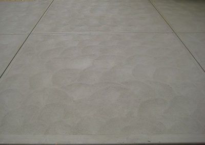 A close up of a concrete floor with a pattern on it.