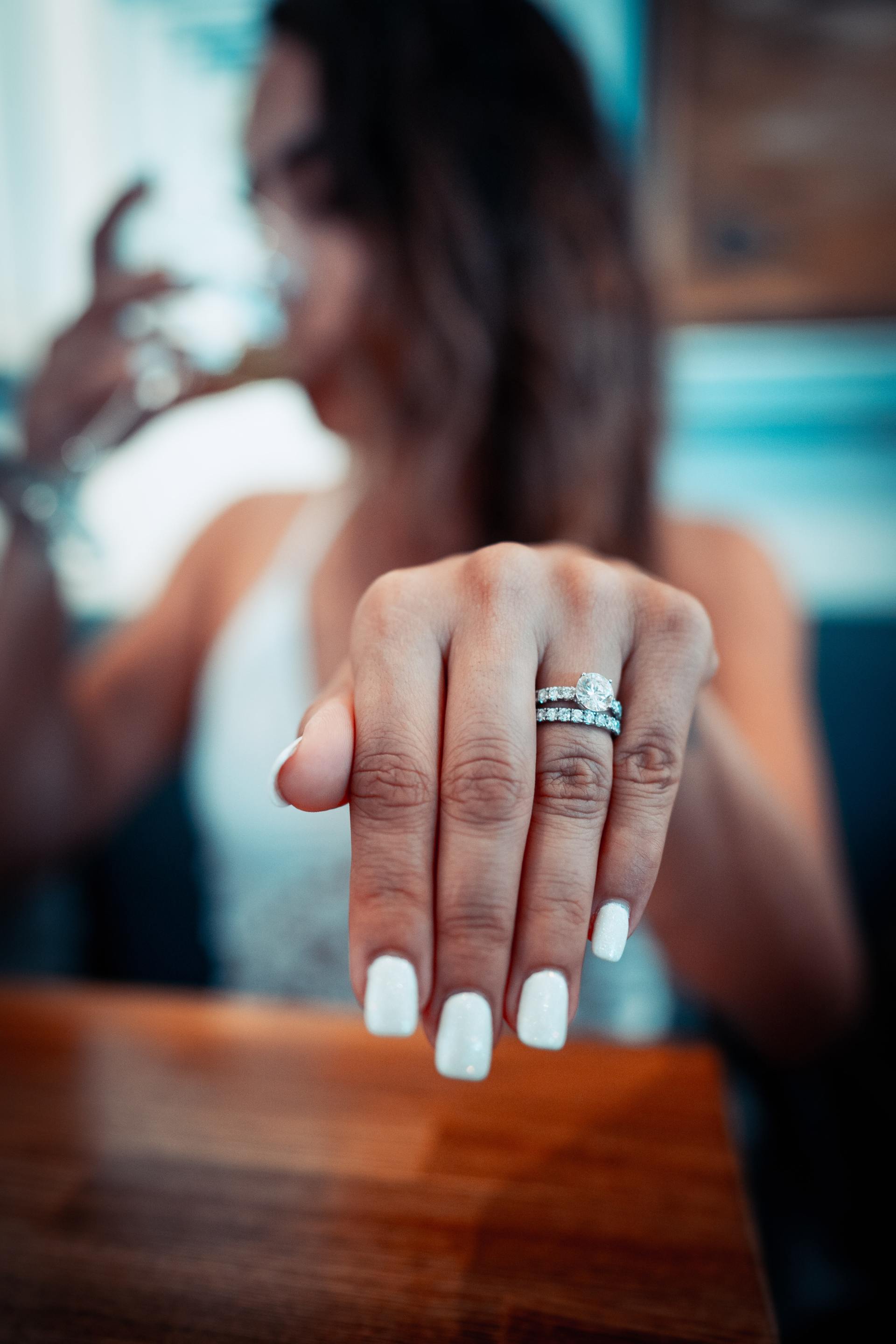 bride showing ring with fresh white manicure