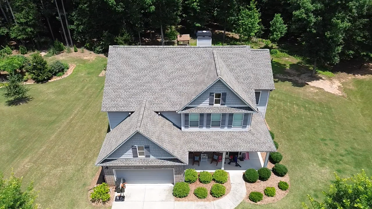 An aerial view of a large house surrounded by trees.