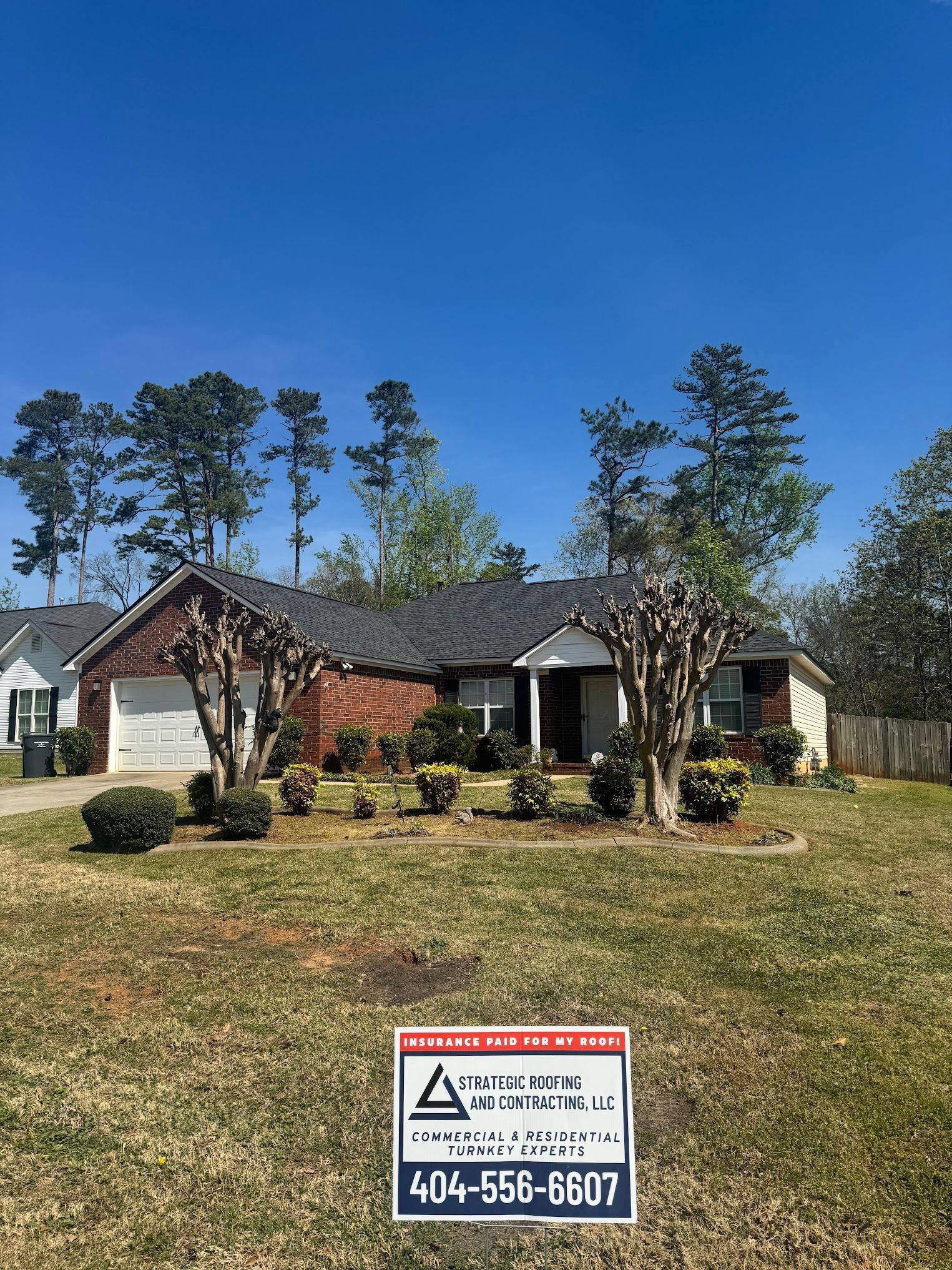A house with a sign in front of it is for sale.