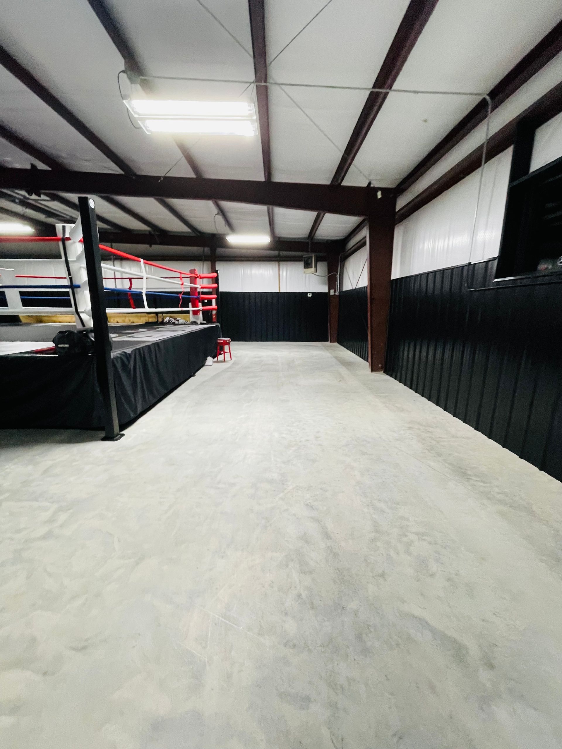 There is a boxing ring in the middle of the room