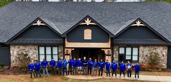 An aerial view of a house with a pool in the backyard.