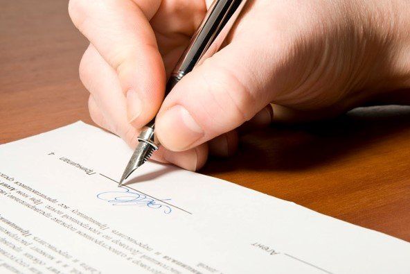 Hand Signing A Document — Idaho Falls, ID — Hart Law Offices, P.C.