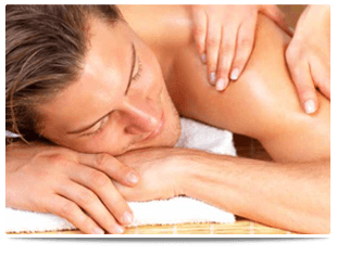 A lady massaging a smiling man's shoulder