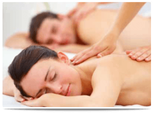 A woman and man both receiving back massages