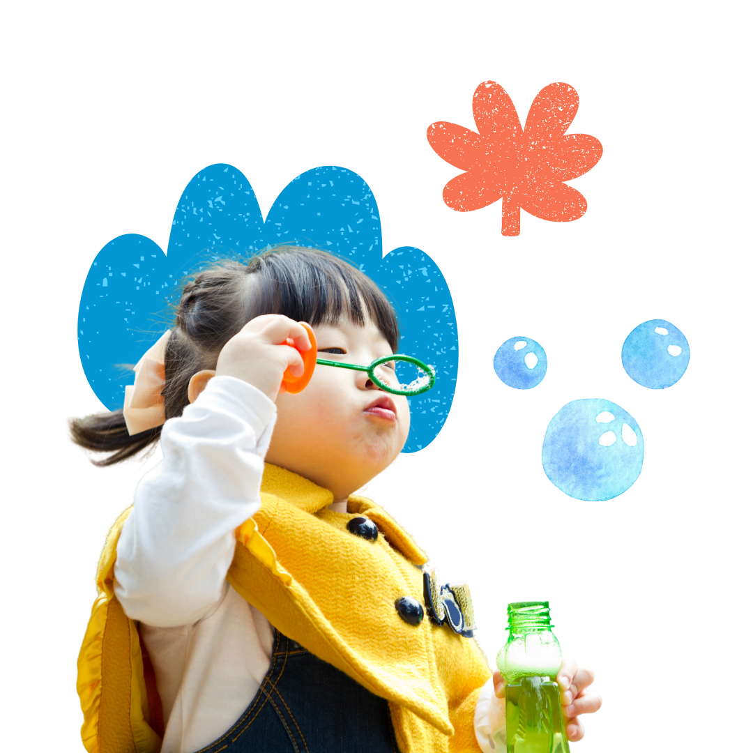 A little girl wearing glasses is blowing soap bubbles