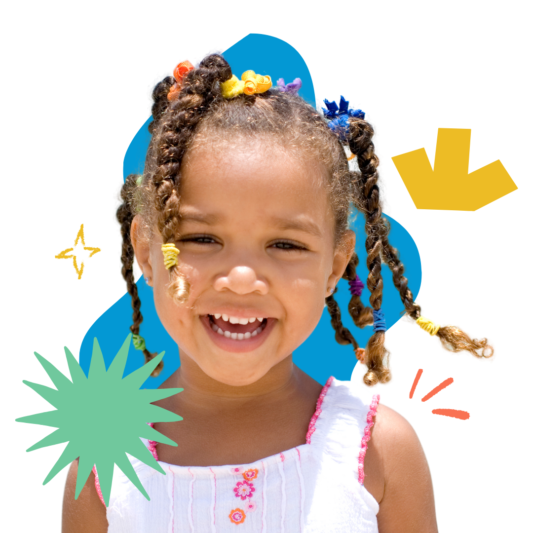A little girl with braids and flowers in her hair is smiling