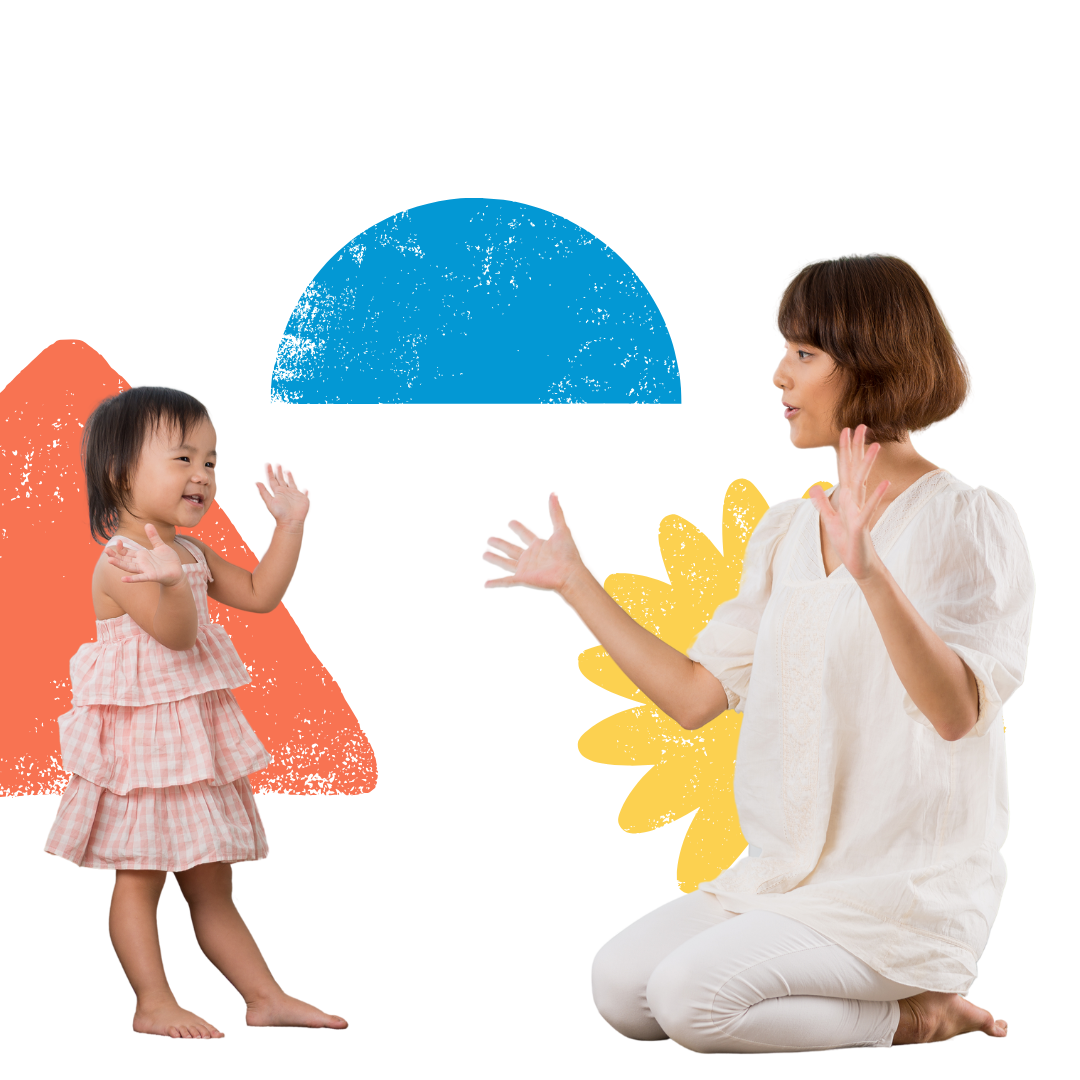 A woman is kneeling down and talking to a little girl