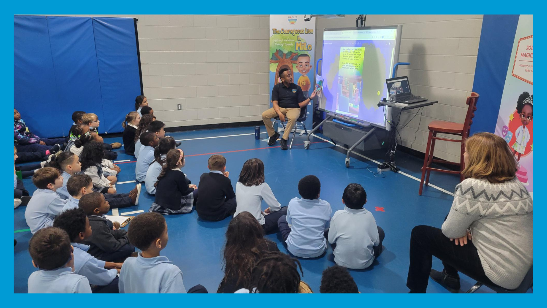 A group of children are sitting on the floor in front of a projector screen.