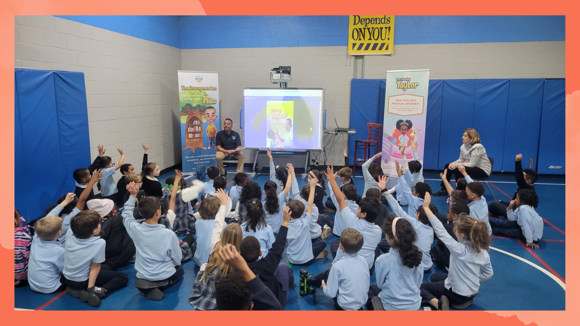 A group of children are sitting on the floor in front of a projector screen.