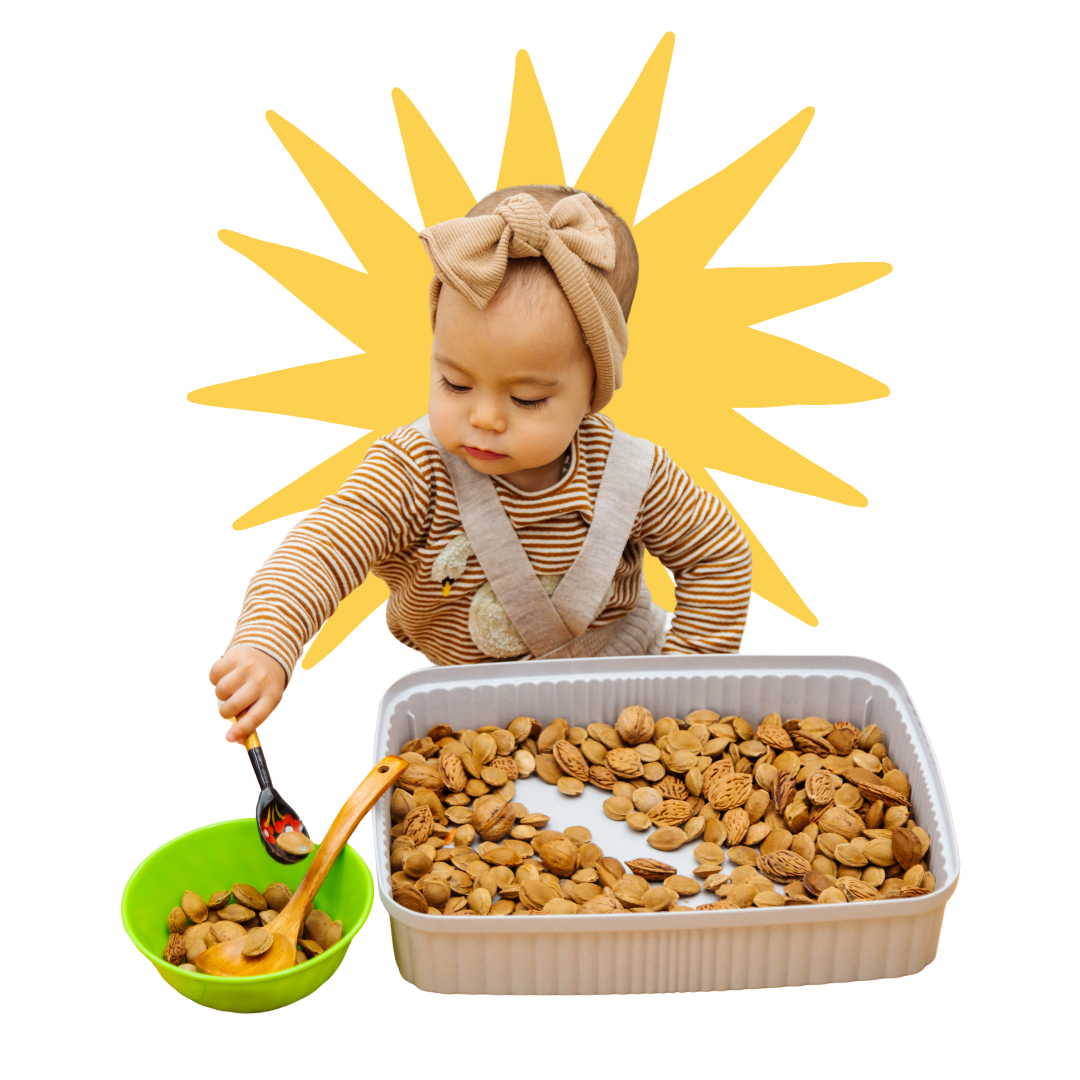 A baby is playing with a sensory bin