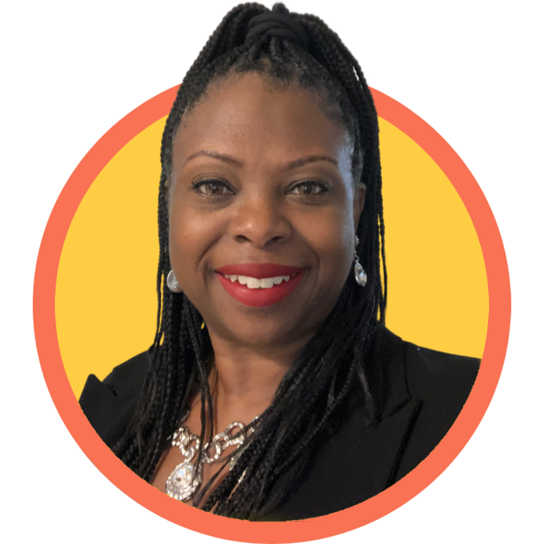 Speech Pathologist, Simone Harrison, smiling, wearing a black blazer, silver jewelry, and red lipstick