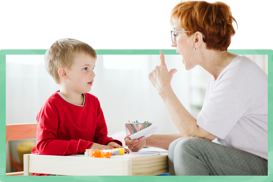 happy child pronouncing a letter during speech therapy with a specialist
