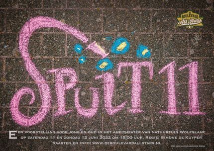 Pink “Spirit” chalk lettering on dark pavement with small blue and yellow designs.