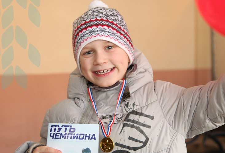 Clergyman in black suit reads book in a building with arched windows.