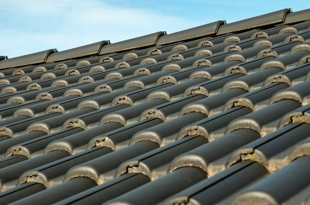 A Close up Of a Tiled Roof with A Blue Sky in The Background — Roof Masters NQ in Douglas, QLD