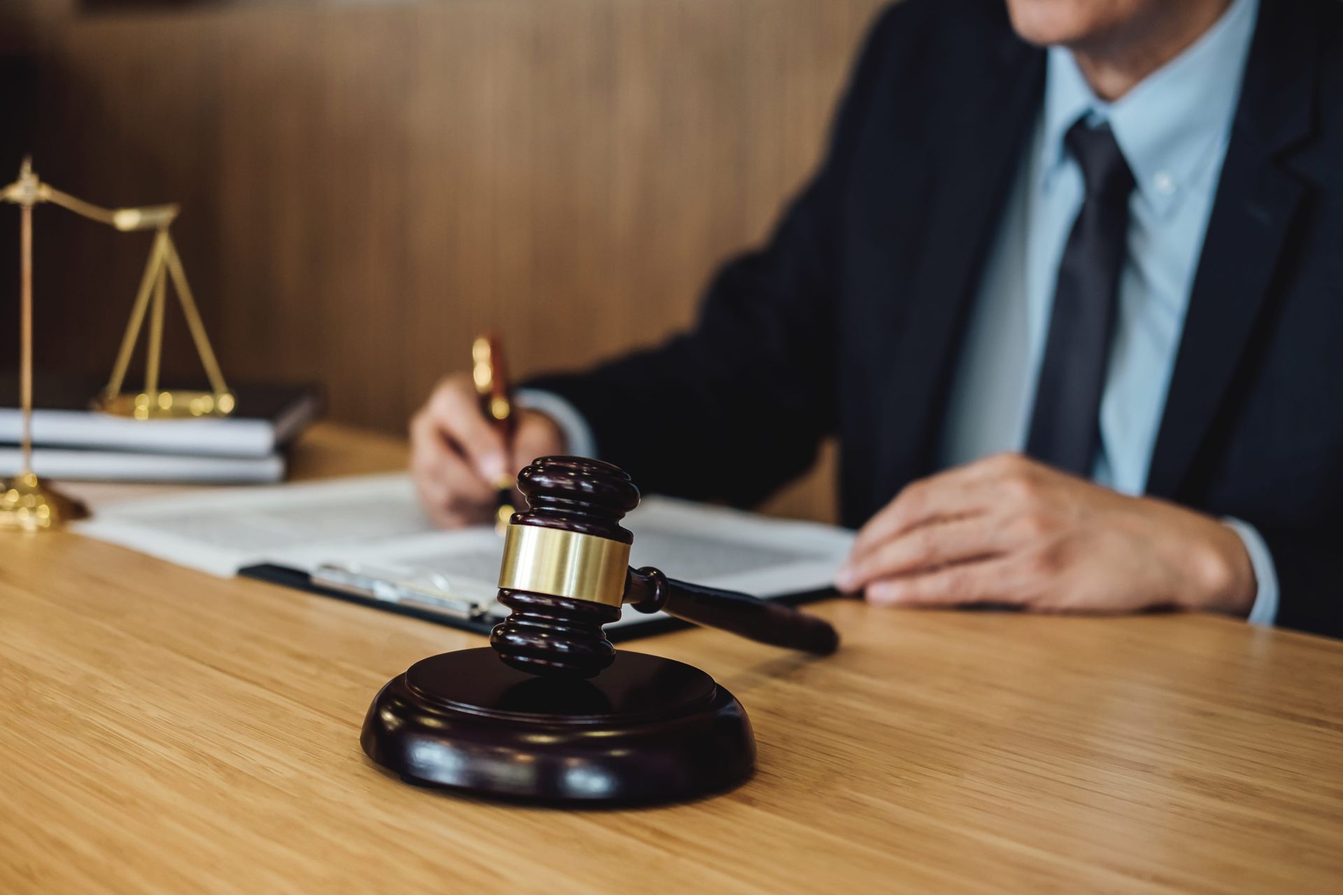 Lawyer at desk with gavel and scales of justice in office