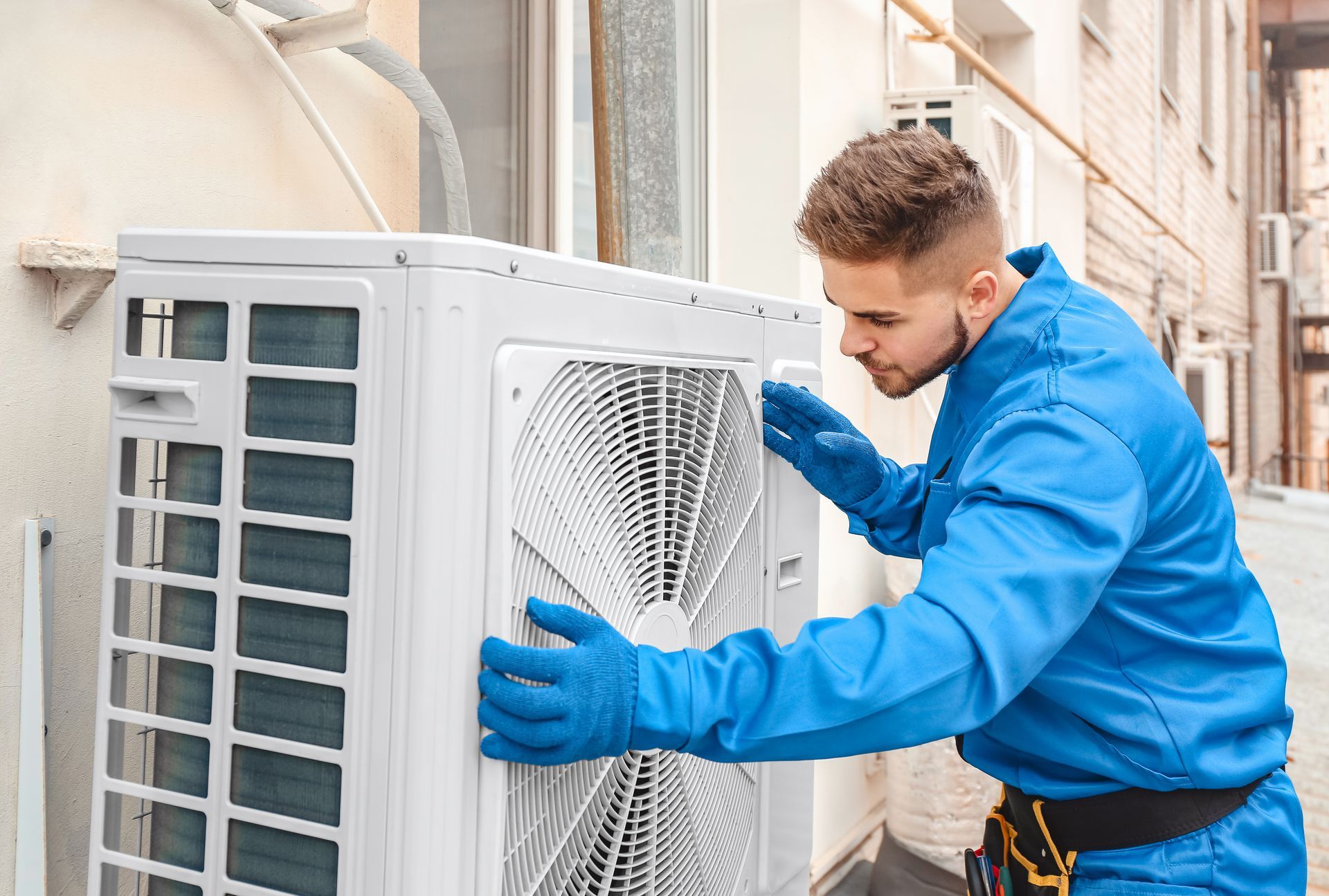 A technician replacing an outdoor unit of air conditioner