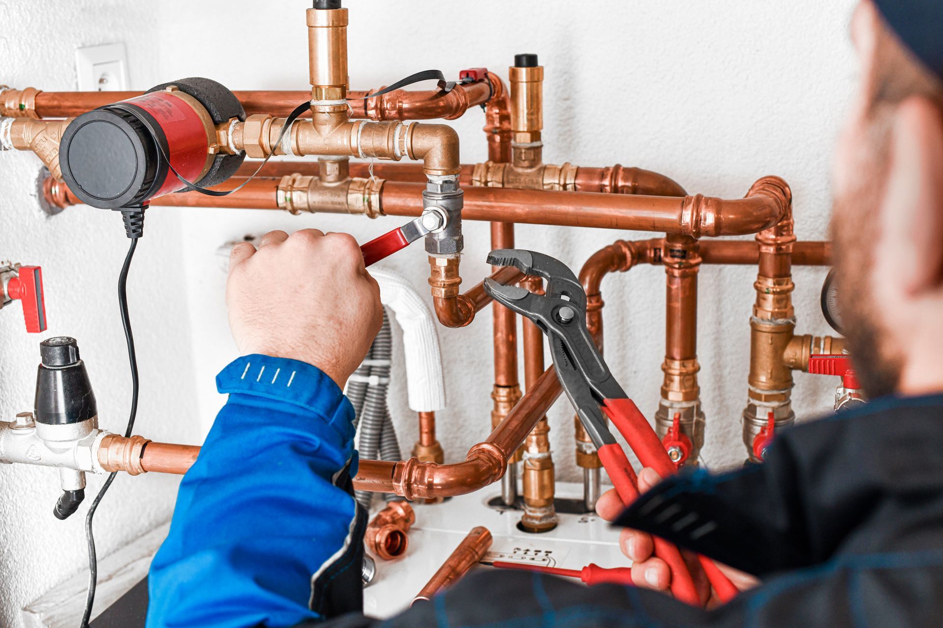 A commercial plumbing contractor installing piping for a plumbing system.