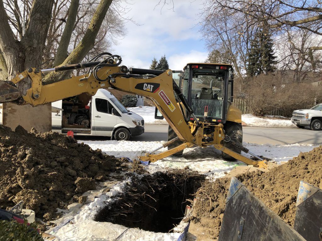 excavator, excavation of main drain by licensed plumbers solve your blockage repair of pipes.