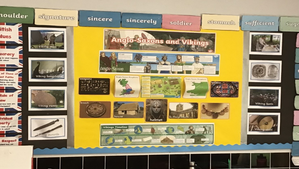 A bulletin board with pictures of ancient england and vikings on it.