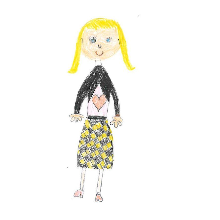 Blonde girl wearing a black jacket over a white top with a heart and a yellow plaid skirt.
