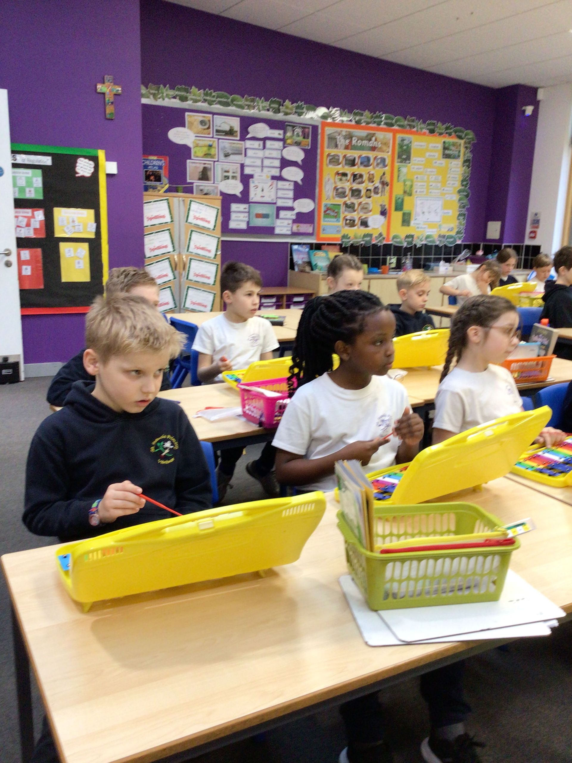 A group of children are sitting at their desks in a classroom