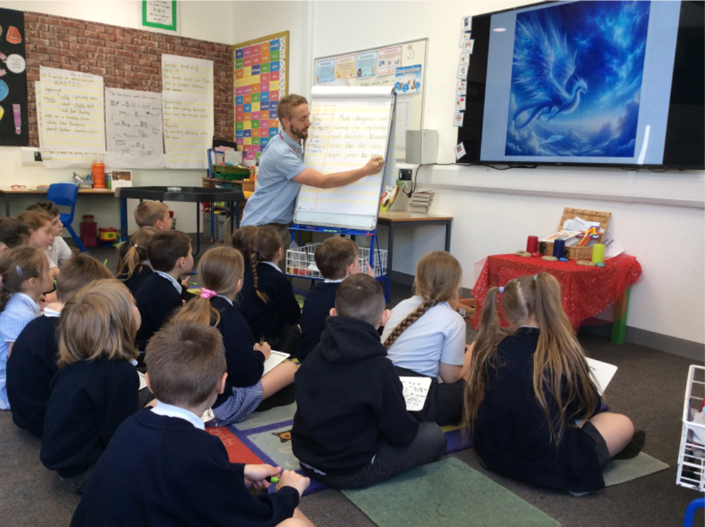 A man is giving a presentation to a group of children in a classroom.