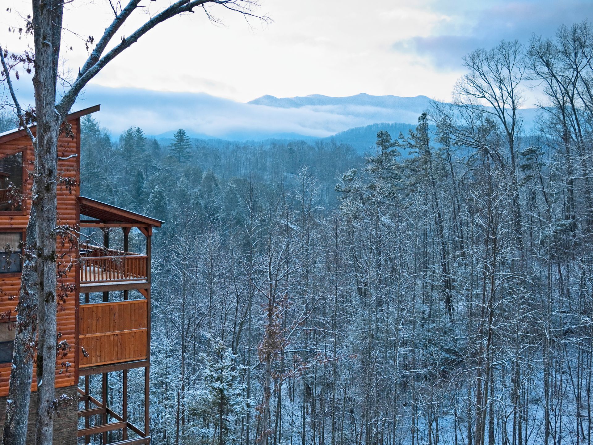 View of a cabin in the Tennessee winter representing the need of low heating cost.