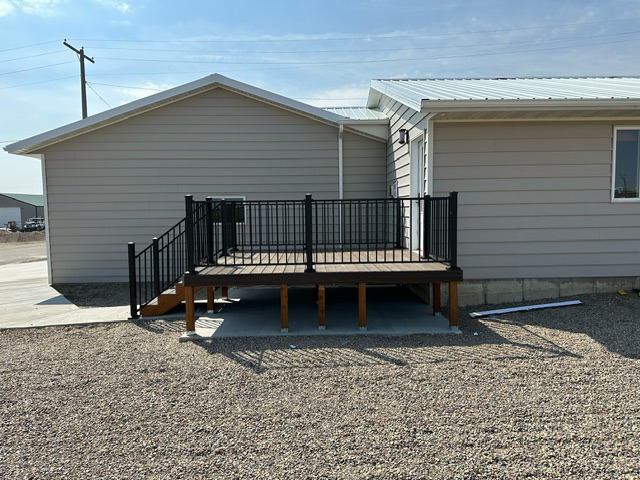 A house with a deck and stairs in front of it