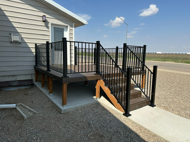 A house with a deck and stairs leading up to it