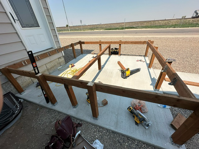 A house with a deck and stairs leading up to it