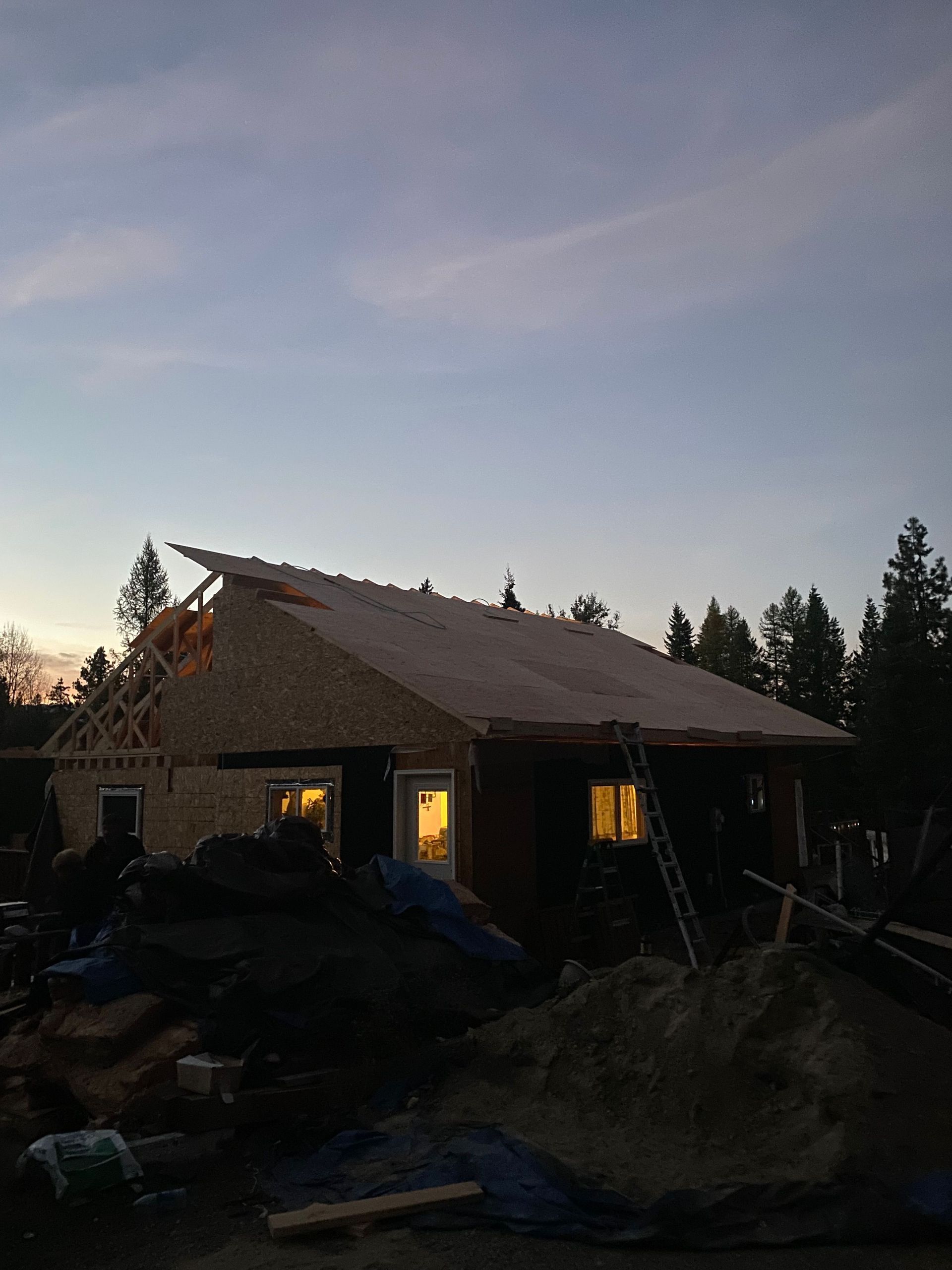 A house under construction with a roof that is being built