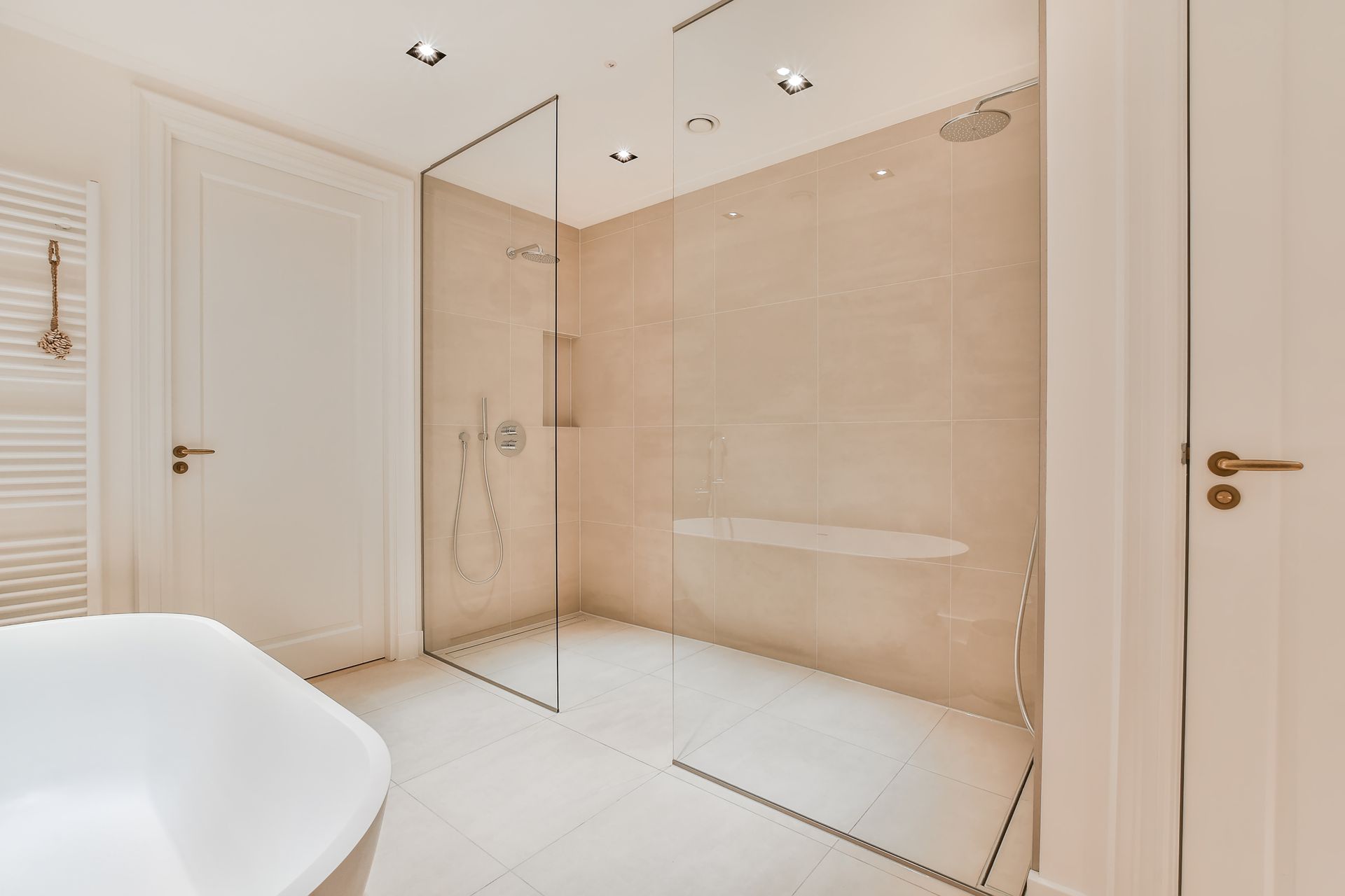 A bathroom with a walk in shower and a bathtub.