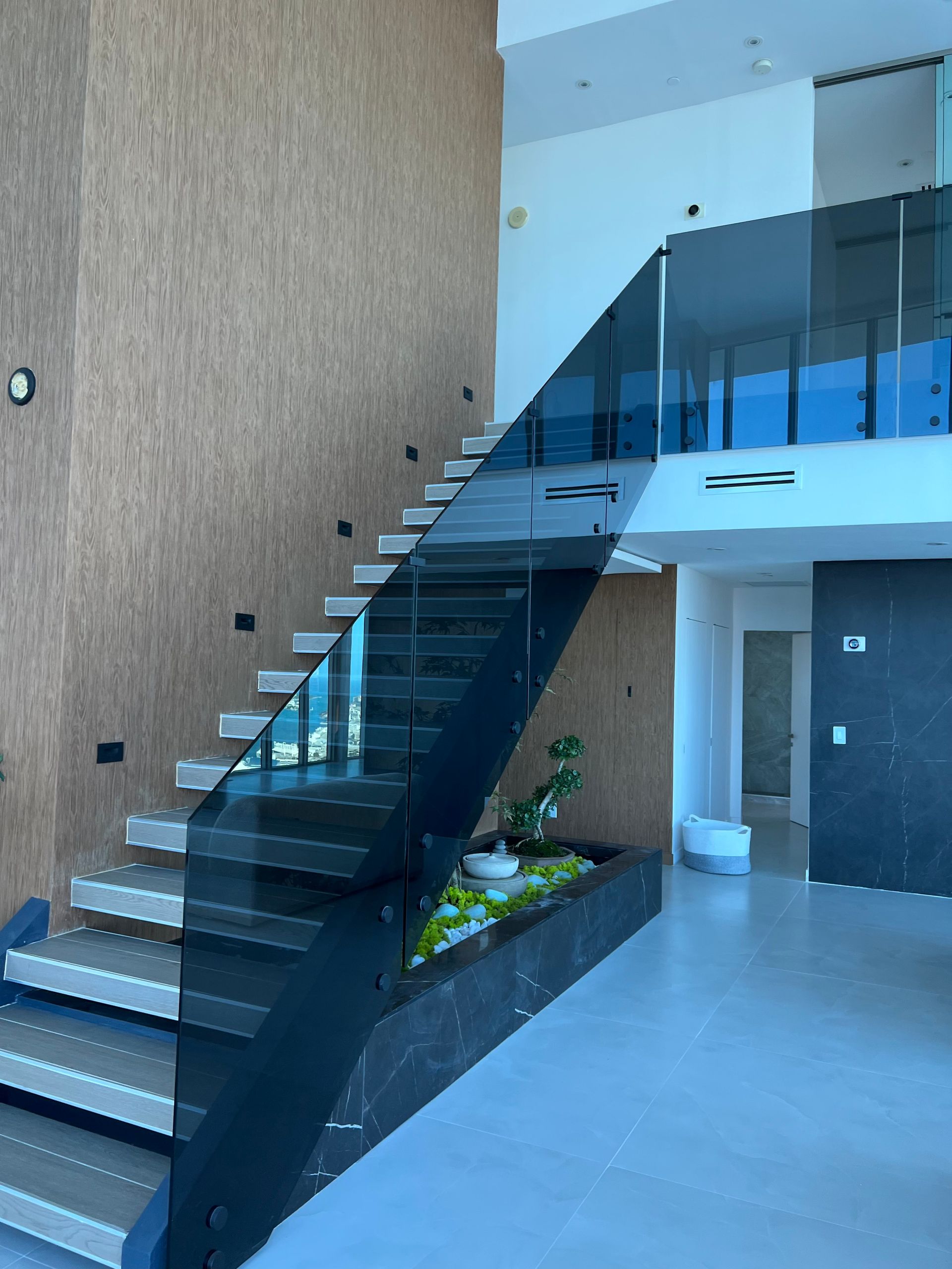 A staircase with a glass railing in a house