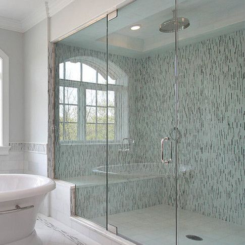 A bathroom with a bathtub and a walk in shower