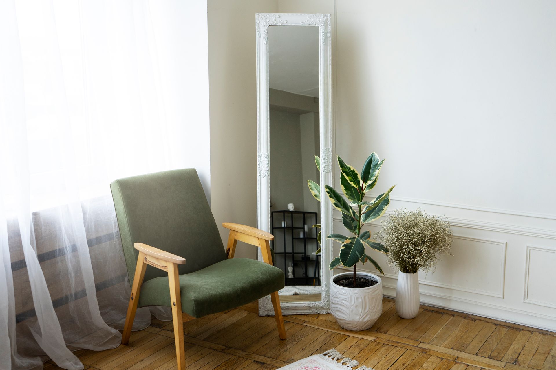 There is a chair and a plant in the room.