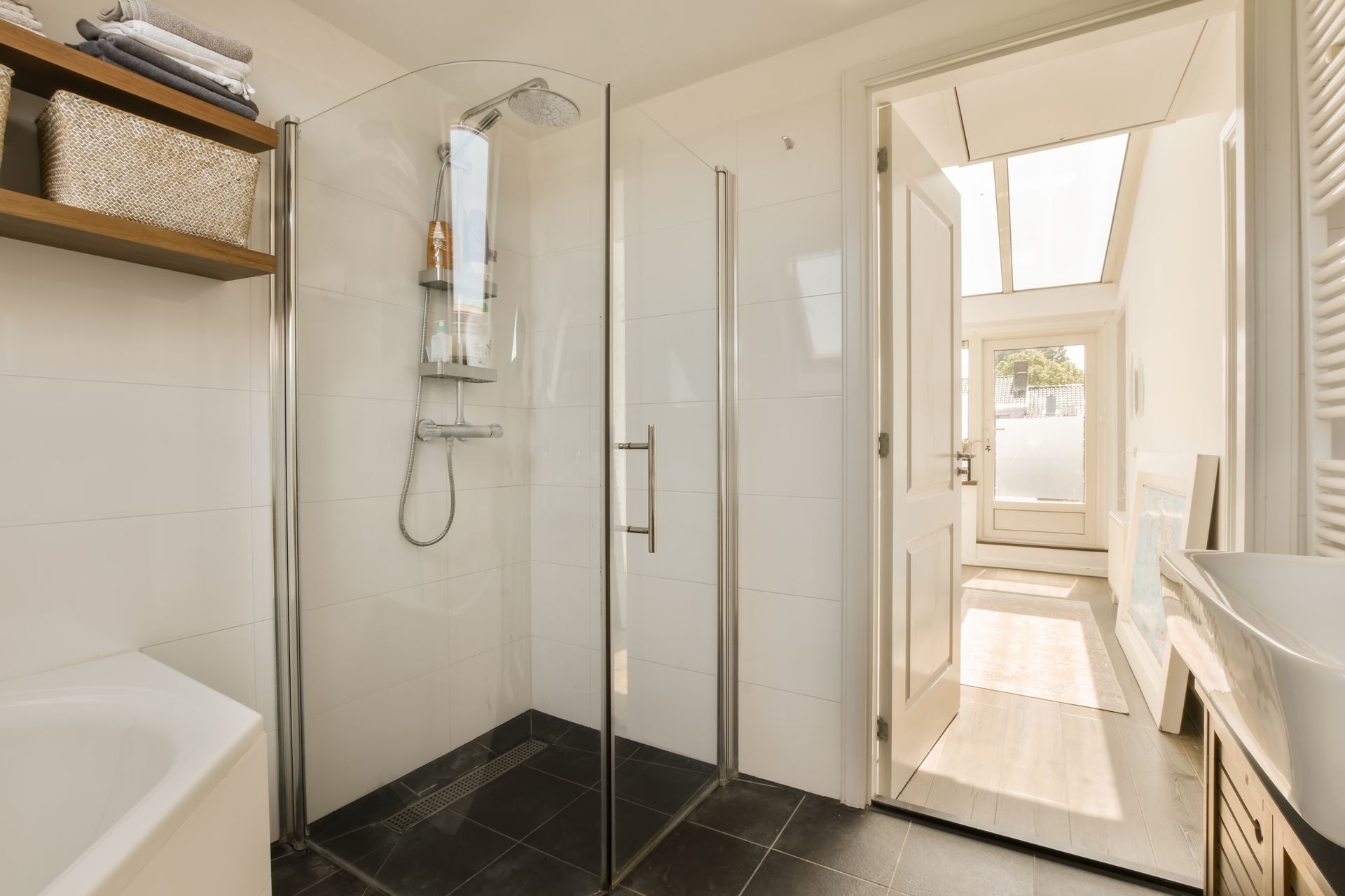 A bathroom with a walk in shower and a bathtub.