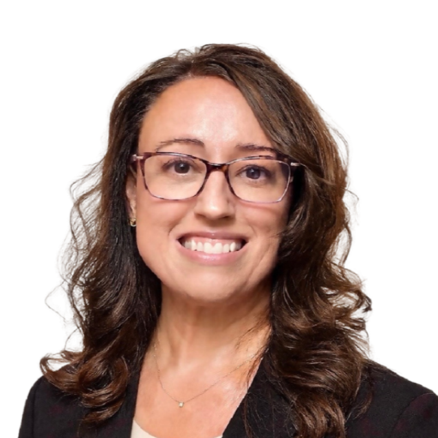 A woman wearing a black dress and a necklace smiles for the camera