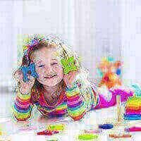 Little Girl Smiling and Playing with Toys at Daycare | Goffstown, NH | Educare Daycare & Learning Center