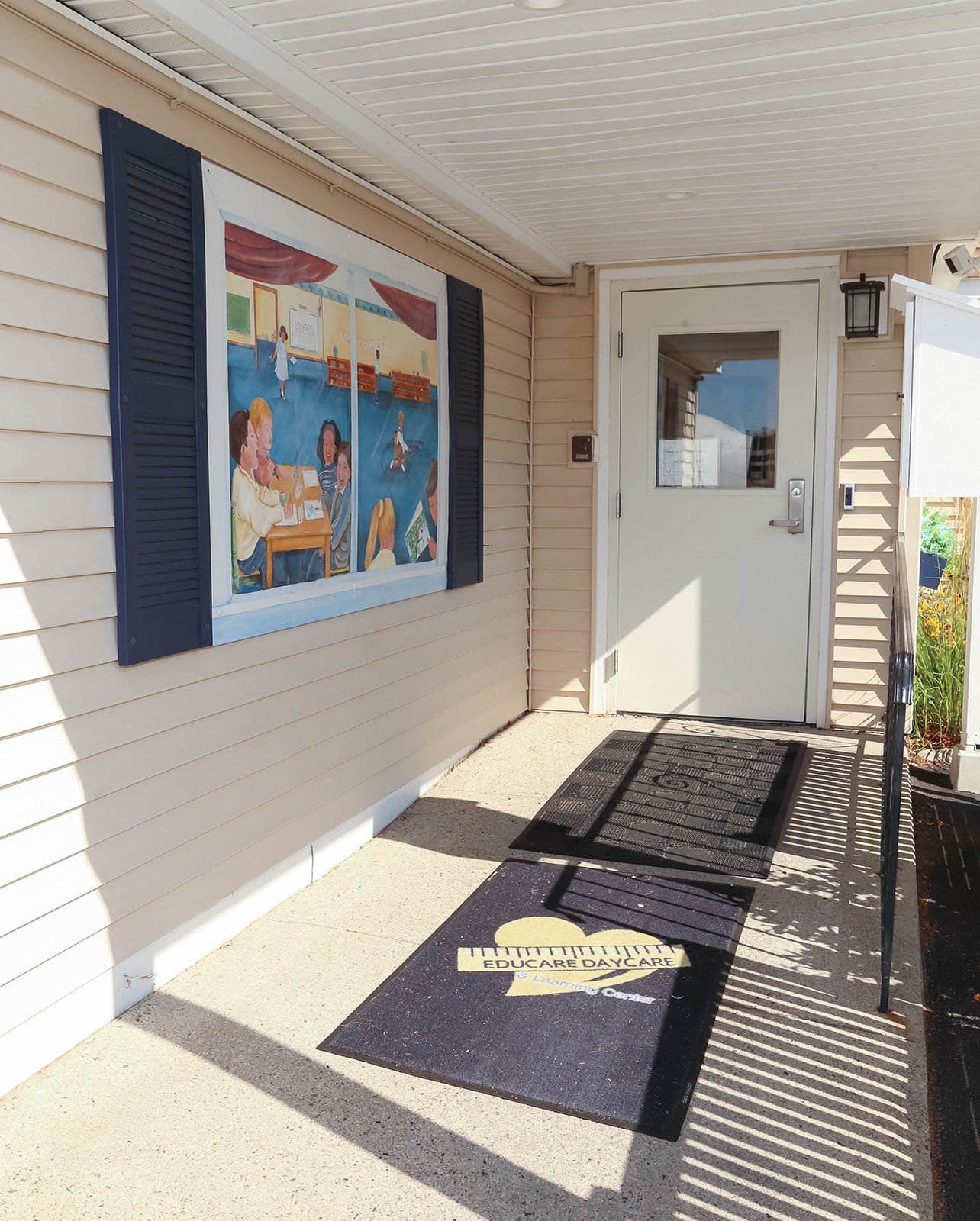 Giant red Connect Four game on a sandy playground.